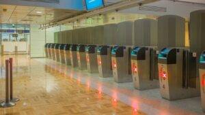 Airport border gates symbolizing new UK visa requirement for Trinidad and Tobago nationals