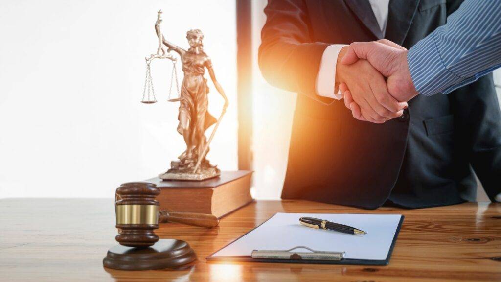 HNW family law solicitor shaking hands with client at legal office