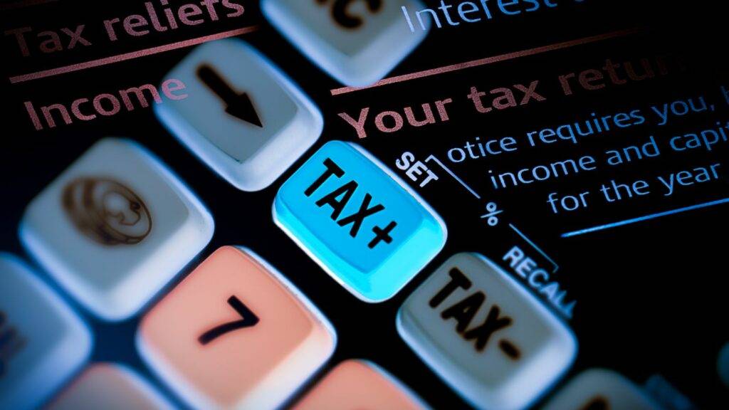 Calculator with TAX+ button and finance terms representing innovative tax advisory services